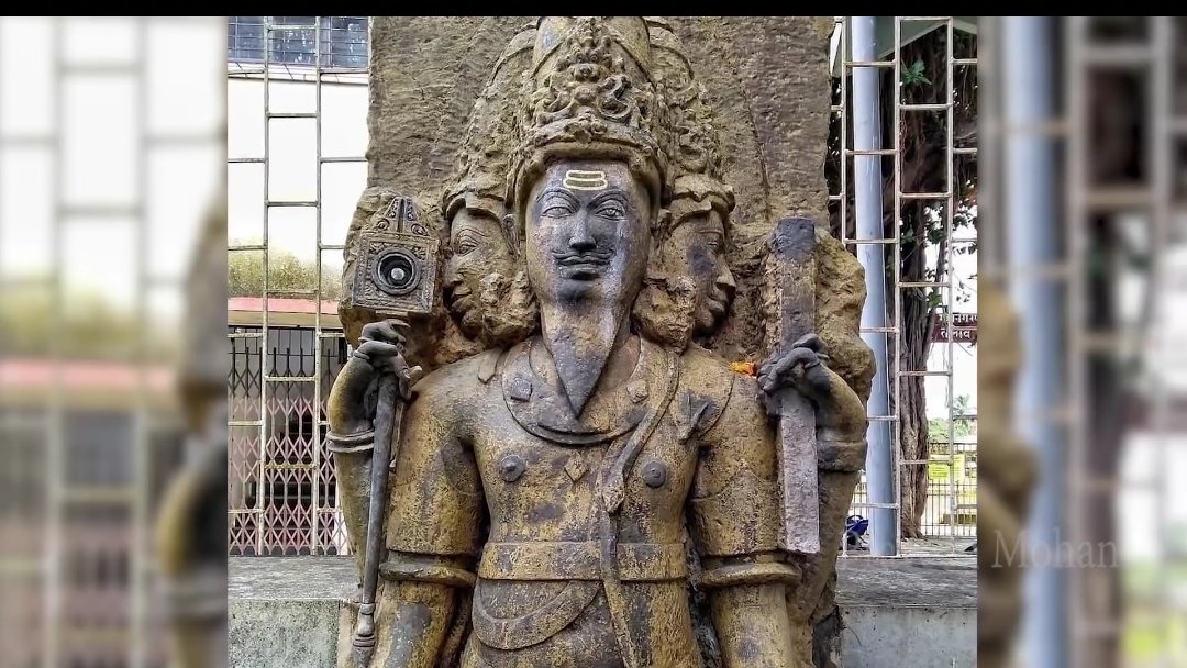 In ancient temples he is represented with 3 heads and holding various weapons Below is a carving from 900 yr old temple