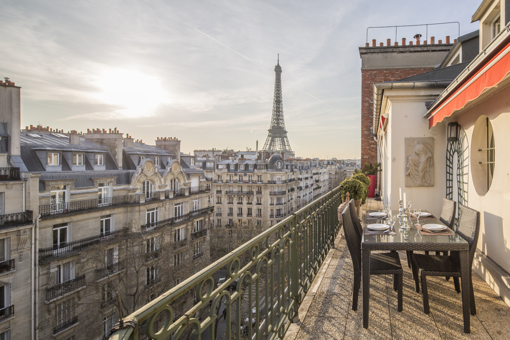 Rich people weren't interested in walking up all those stairs, so the higher you got in the house the smaller and cheaper the apartments got. Today we have elevators, so these houses are more economically homogenous than they used to be, often the top floor is the most expensive.