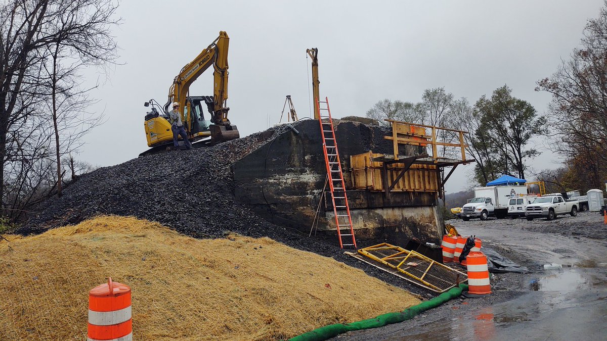 Repair underway of fallen Norfolk Southern train bridge, Salem, Va., Wednesday. Rain falling.