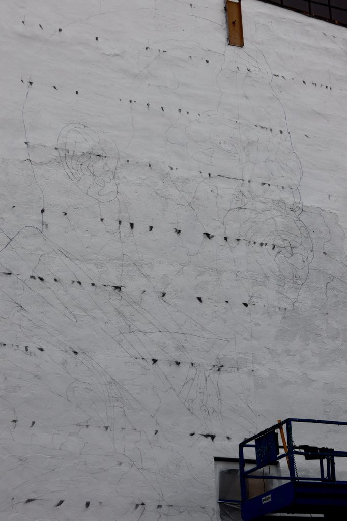 The mural on State Street is based on a photograph by Danny Lyon of John Lewis in 1963. The outline of Lewis happened in the overnight hours.