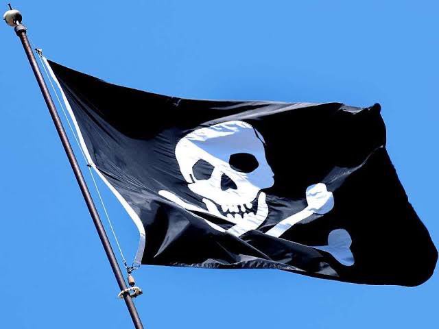 Реящий. Черный флаг. Темный флаг. Пиратский флаг. Развивающийся пиратский флаг.