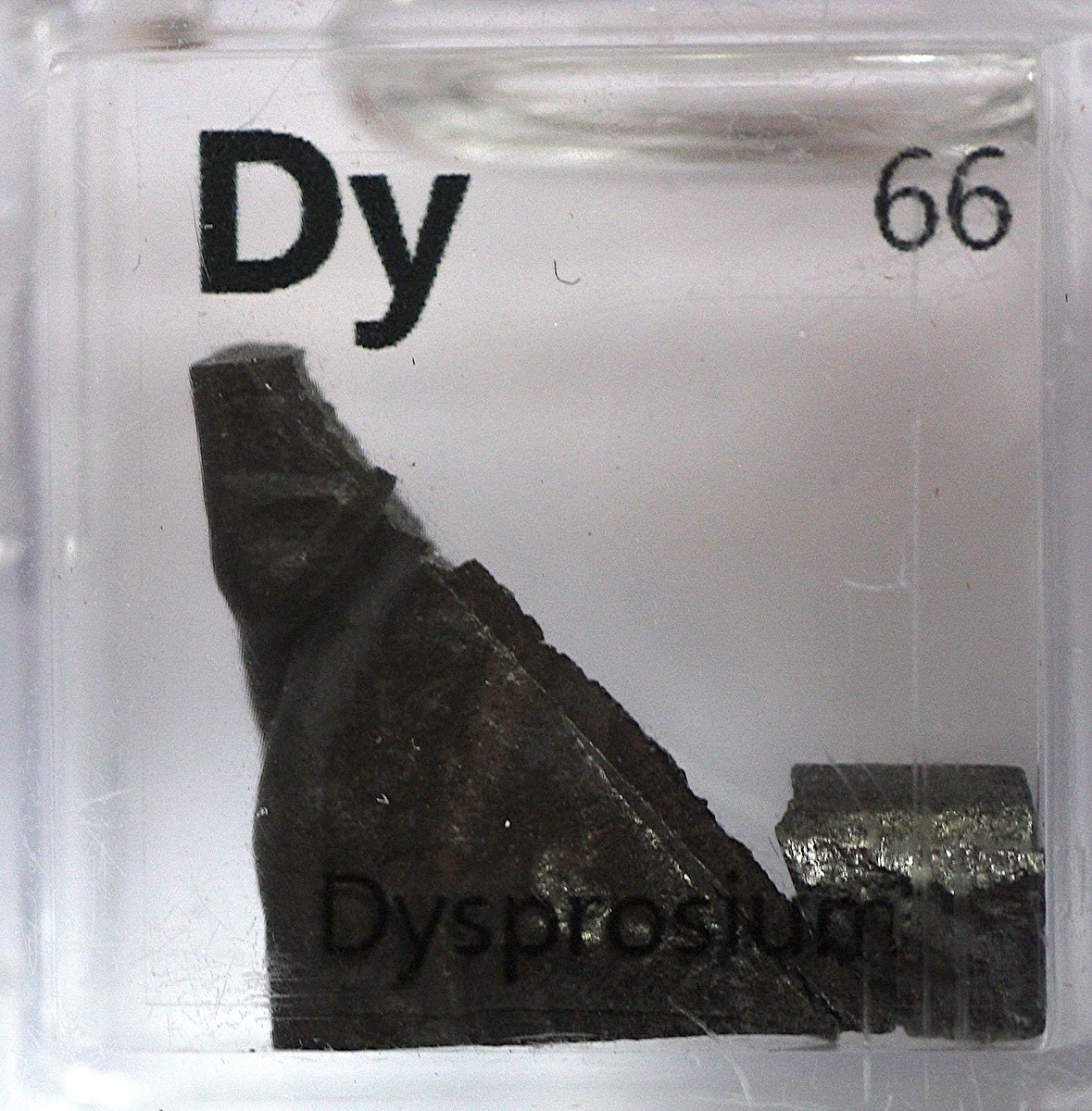 Dysprosium  #elementphotos. White compound is dysprosium triflate (Dy(O3SCF3)3). Love the texture on some of these samples.