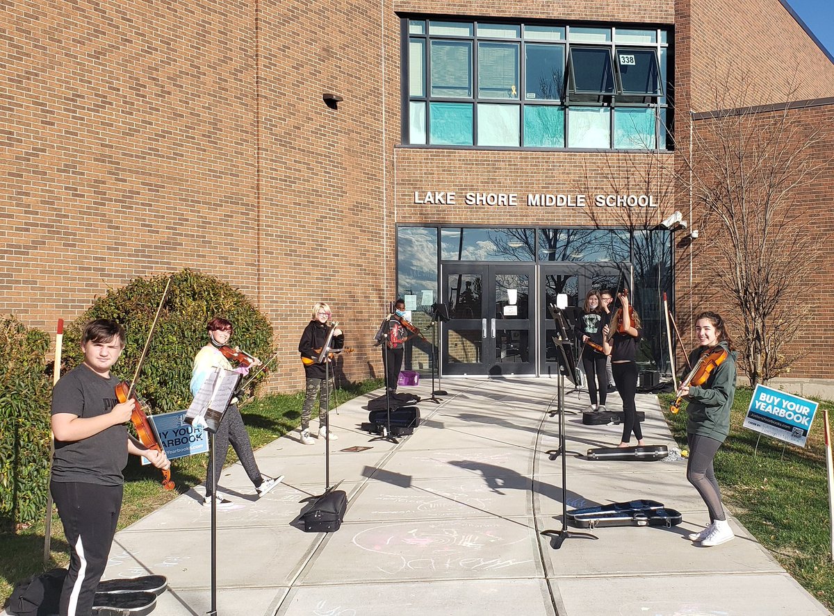 The Green 8th Grade Orchestra "takin' it to the streets." (Thank you Doobie Bros.) Well, on the sidewalk outside the front door which also happens to be under our classroom window.