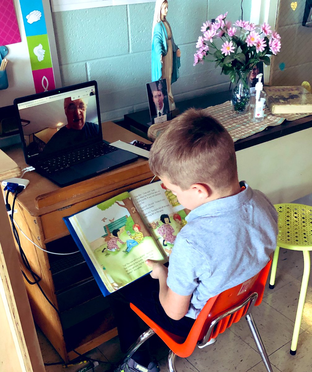 PrincipalGrey's tweet photo. #COVID19 prevents visitors in the classroom, but 1st graders @Stcharlesgrnvl are able to connect with long-standing volunteers from the parish who listen to them read, and support the classroom literacy instruction! @dogrschools #catholiccommunity https://t.co/0xDEX80dZy