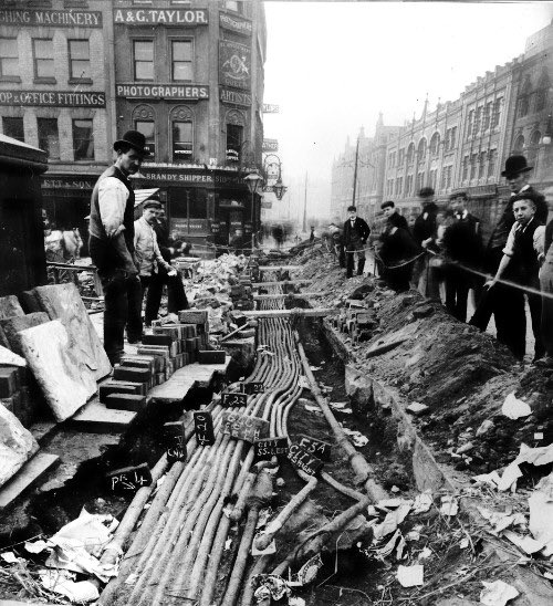 There were over 30 miles of cable produced with a joint every 20 feet!! These photos are from early 1900s cable laying. This was still a very new thing for ordinary folk to see. Trenches full of snaking power cables. What magic is this? [15/20]