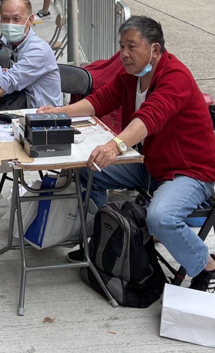 This dude sitting here with a stack of iPhone 12 pro Max while smoking a cig with a gold Rolex and not wearing socks is the epitome of Kowloon.