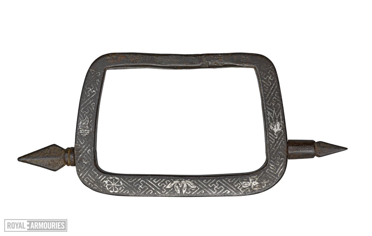  III.2281(3/10) Arms and armour were often decorated with lucky symbols to protect their bearers in combat. This 19th-century Chinese knuckle duster is decorated in silver overlay with the 'Ba Ji Xiang' (Eight Lucky Buddhist Emblems) XXVID.66