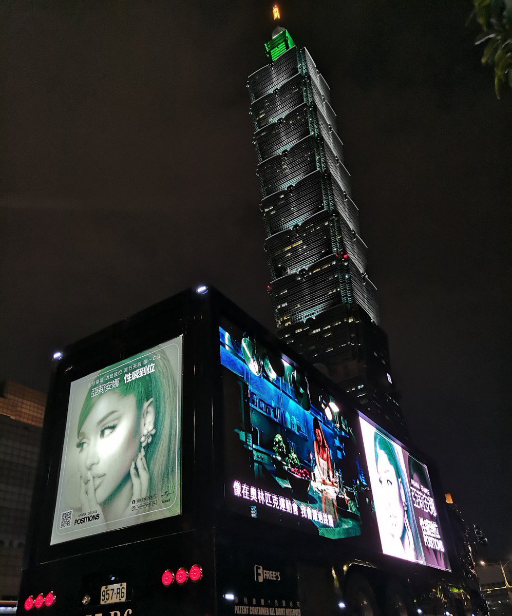 ArianatorTW's tweet photo. official #positions promo truck near Taipei 101 in Taiwan 🇹🇼🤍✨ we are so proud and lucky to be Taiwan Arianators 🥰 @ArianaGrande https://t.co/k9X85w9UIS
