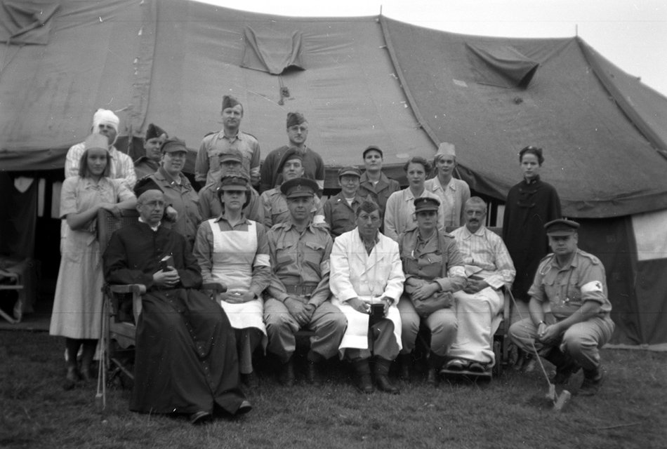 Sometimes we even recreated an entire field hospital.I sit next to the priest.