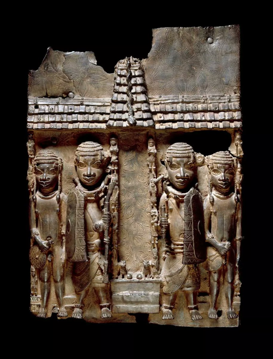 Brass plaque showing Benin court officials flanking a palace entrance or altar. Benin. 16–17th century..6/10.