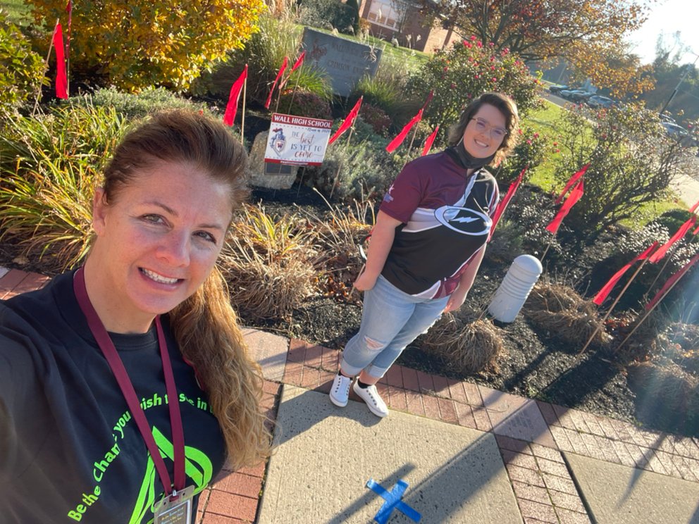 WallTwpSAC's tweet photo. More 2020 Red RIbbon Week Photos: 
WHS 12th Grader, Renee Grunwald assisted Mrs. Regenye with placing Red Ribbon Flags in Front Entrance Garden on Monday 11/9/20. @WHSDeltaClub @WallTwpSchools https://t.co/FBEnU5hsbA