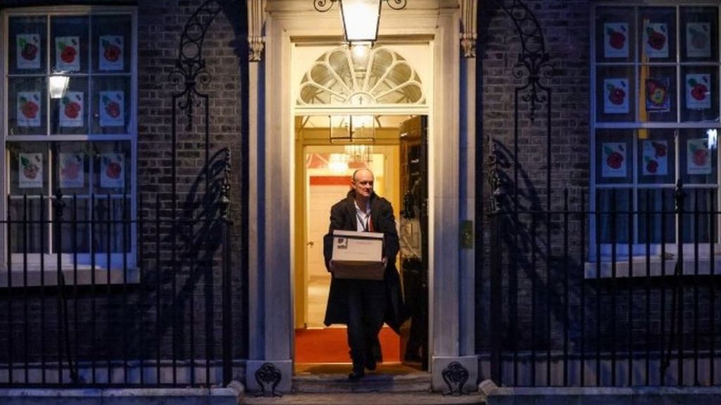 A Reuters photograph of Dominic Cummings leaving Number 10 Downing Street carrying a box on 13 November 2020
