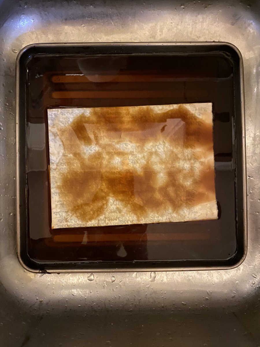 12/ first I soak the prop briefly in some plain water in our sink. Then take the paper out, dump out the water, fill the tray with the decaf coffee mixture, and into this lovey bath goes the damp paper