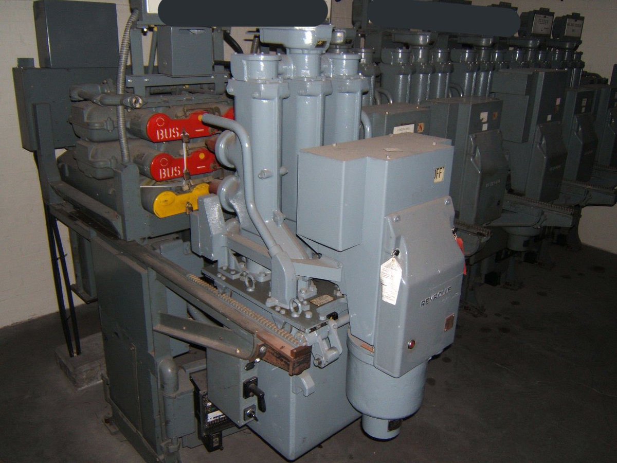 Here’s a panel of duplicate busbar 11kV C gear “racked out”. Notice the safety shutters which close over the LIVE busbar spout orifices and circuit spouts. These are always LOCKED CLOSED for safety  [21/26]