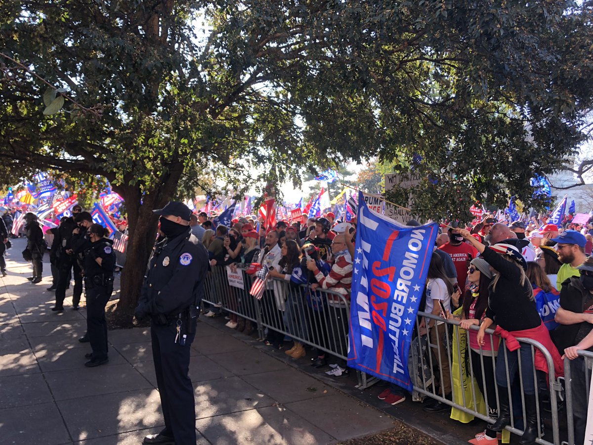 Riot cops line up outside the Supreme Court, facing their shields toward the relatively small counterprotest as thousands of Trump supporters continue to fill the street. Lost Trump supporters keep wandering over as antifascists yell “Turn around!”  #DCProtests