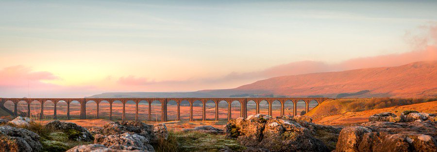 GenealogyBeech's tweet photo. On a misty and miserable Sunday, a Tim Hill photograph of a #Winter sunrise over the Ribblehead viaduct, one of my favourite structures. Designed by John Sydney Crossley, chief engineer of the Midland Railway it opened in 1875 #yorkshire #yorkshiredales https://t.co/TDjo7G5juC