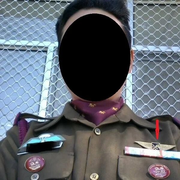 Selfie by a Special group operative, arrow pointing towards SG insignia wore by SG operatives.