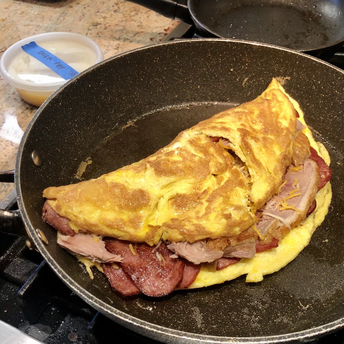 Keep your turkey sandwiches... my son just took #ThanksgivingLeftovers to the next level. Witness... the #TurduckenOmelet. Five eggs, a package of turkey bacon, sliced duck breast, and a little cheese... all cooked in duck fat.