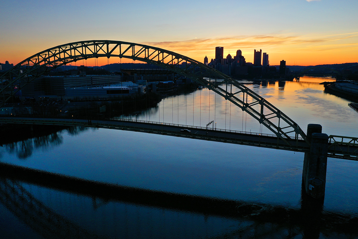 Aerial photo at sunrise of the West End Bridge and downtown Pittsburgh in the background. 