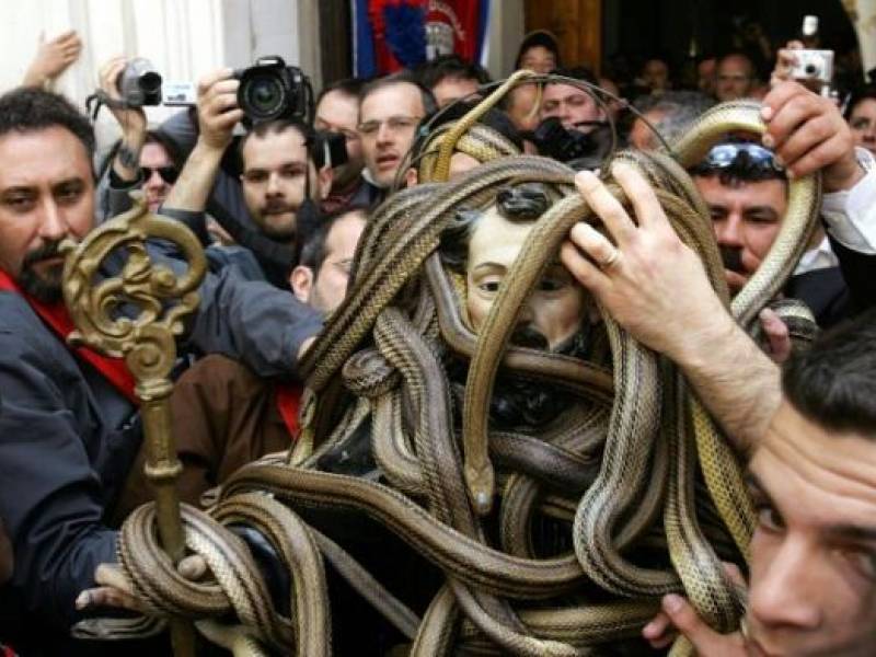 To be clear I made up that god. But there are fun examples. Again from my partner - xe loves folklore - the ancient goddess of snakes, Angitia, was reskinned as Saint Dominic. Pictured: an absolutely legit catholic celebration. Yep those are snakes. https://twitter.com/jackdaw_writes/status/1245652585870061570