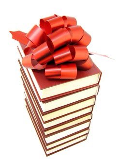 Stack of books with a gift bow on top.