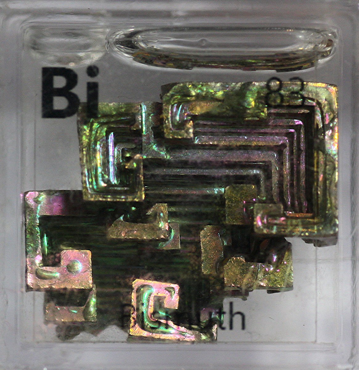 Bismuth  #elementphotos. Bi naturally has a beautiful silver look, but when crystallised in the air it forms an oxide layer on the surface. Different depths of oxide layer give different colours (same effect happens in an oil slick), producing lovely multicoloured crystals.
