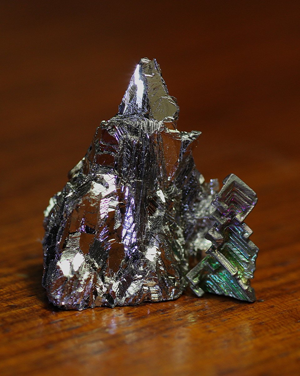 Bismuth  #elementphotos. Bi naturally has a beautiful silver look, but when crystallised in the air it forms an oxide layer on the surface. Different depths of oxide layer give different colours (same effect happens in an oil slick), producing lovely multicoloured crystals.