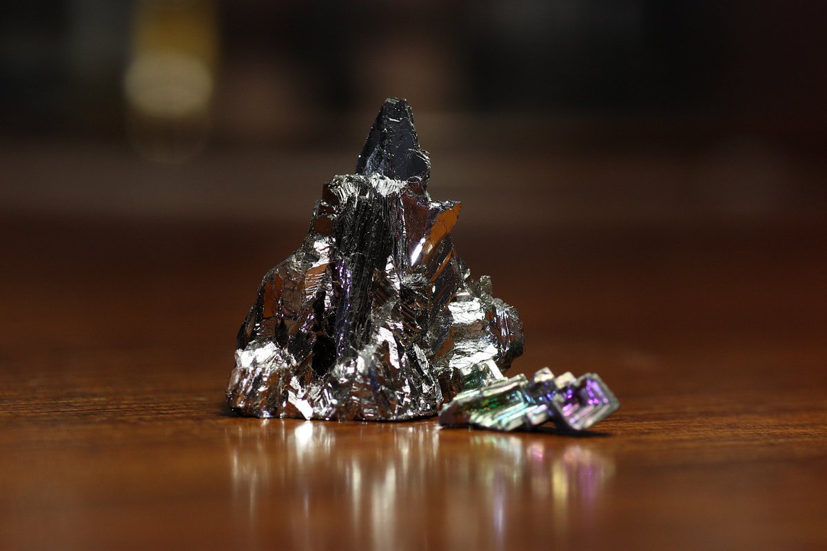 Bismuth  #elementphotos. Bi naturally has a beautiful silver look, but when crystallised in the air it forms an oxide layer on the surface. Different depths of oxide layer give different colours (same effect happens in an oil slick), producing lovely multicoloured crystals.