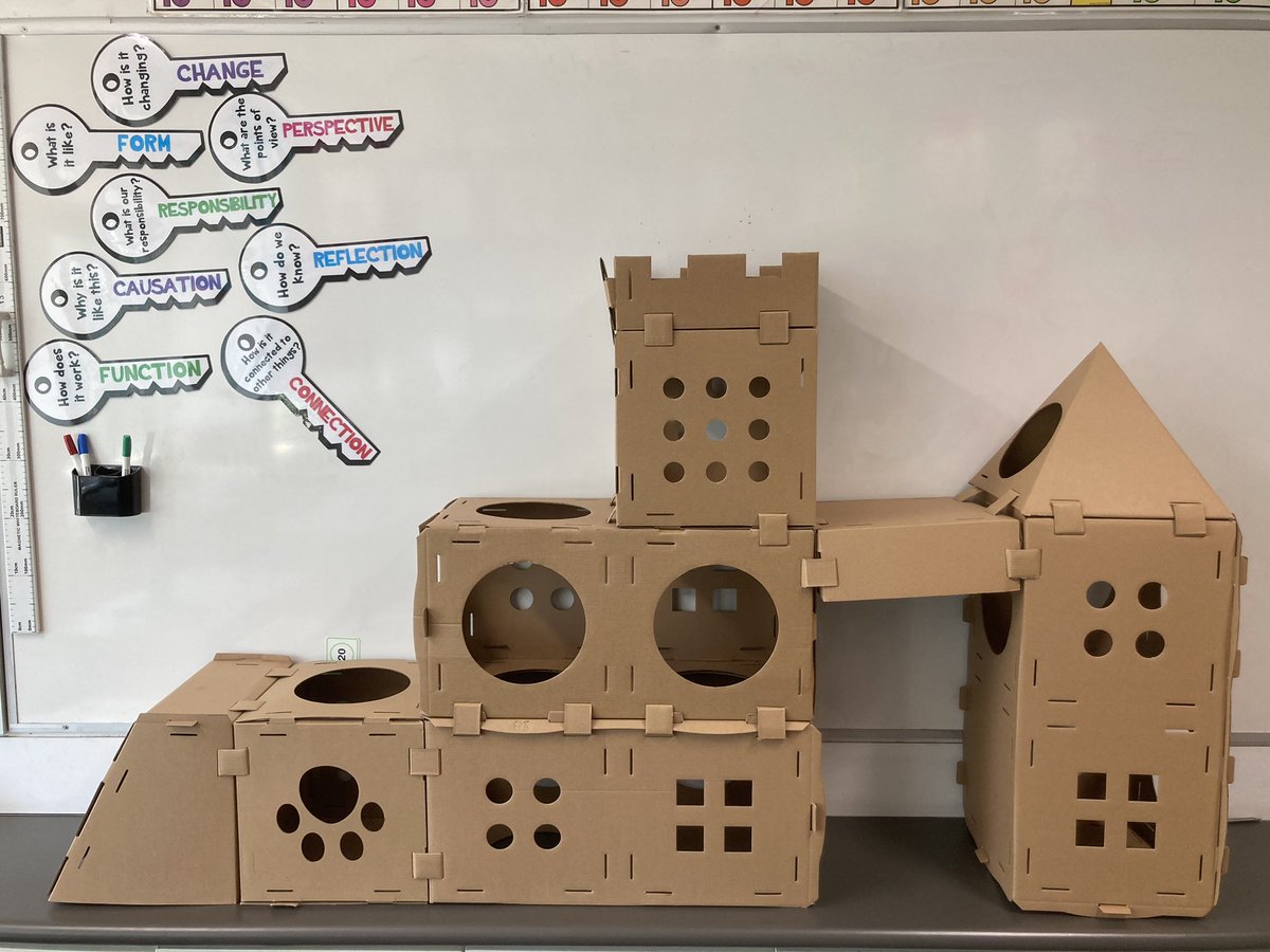 3D shape provocation today. Students came in to cardboard all over the room. Without any direction they started folding the tabs &amp; creases &amp; eventually started putting prisms &amp; pyramids together. Once they’d finished they used connector tabs to join it together. #ibpyp #inquiry