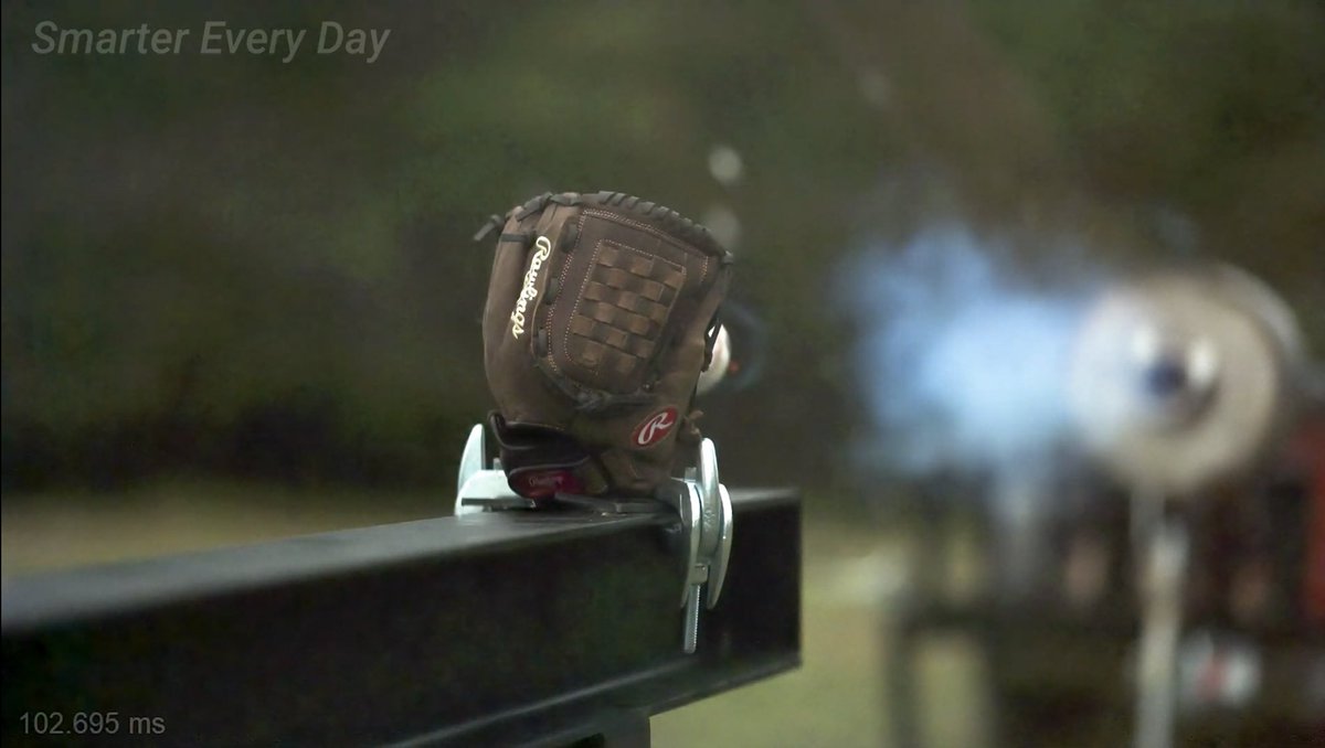 If you watch closely at 10 mins 50 sec into the video, and slow it down, you’ll see a tiny glimmer of orange trailing the baseball *before* it impacts the glove What’s happening here?