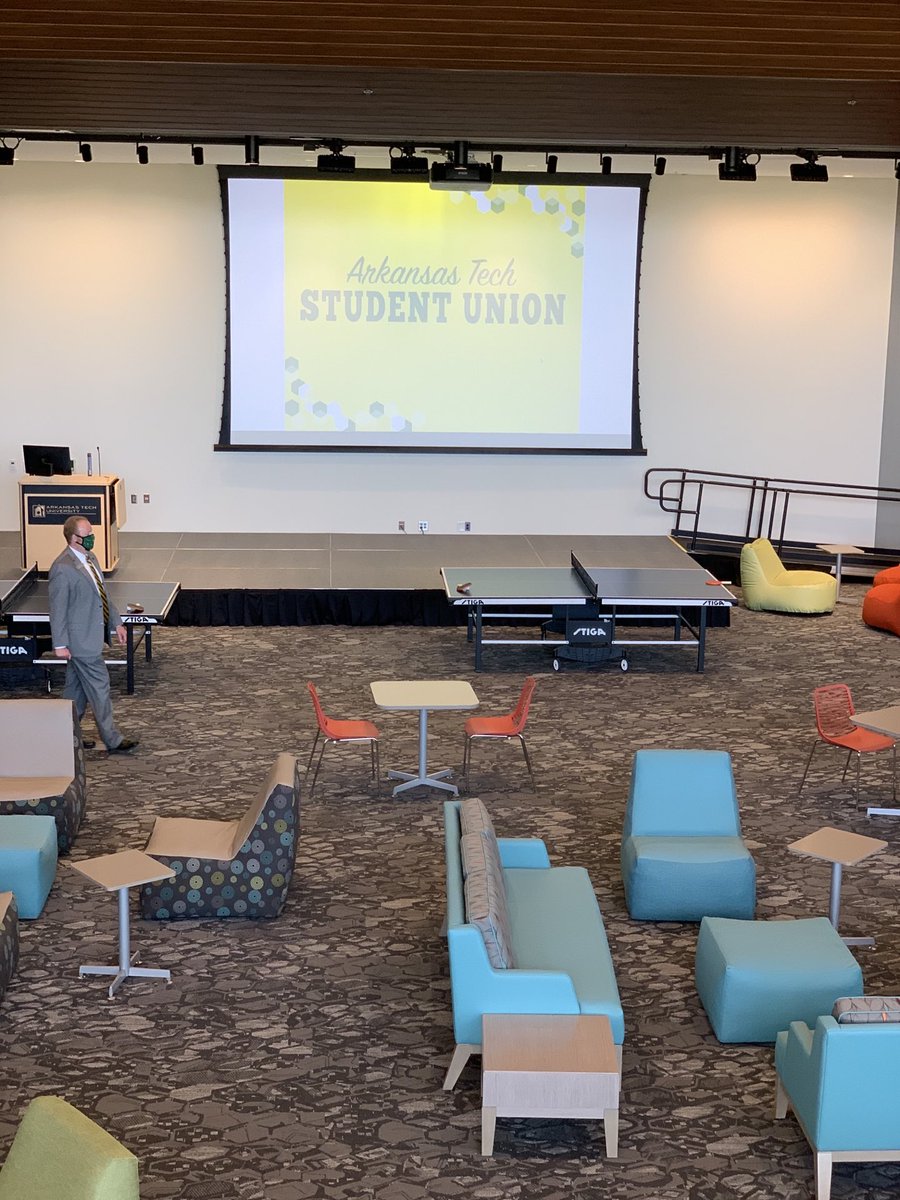 drrbowen's tweet photo. A stage for performances, gaming areas, a smoothie bar, pool, ping pong, great places to hangout with friends, a great view of the football stadium AND a fire pit. Just a few of the amenities in the new ⁦@ArkansasTech⁩ Student Union. Come check it out! 💚💛 https://t.co/QoR7lFasZN