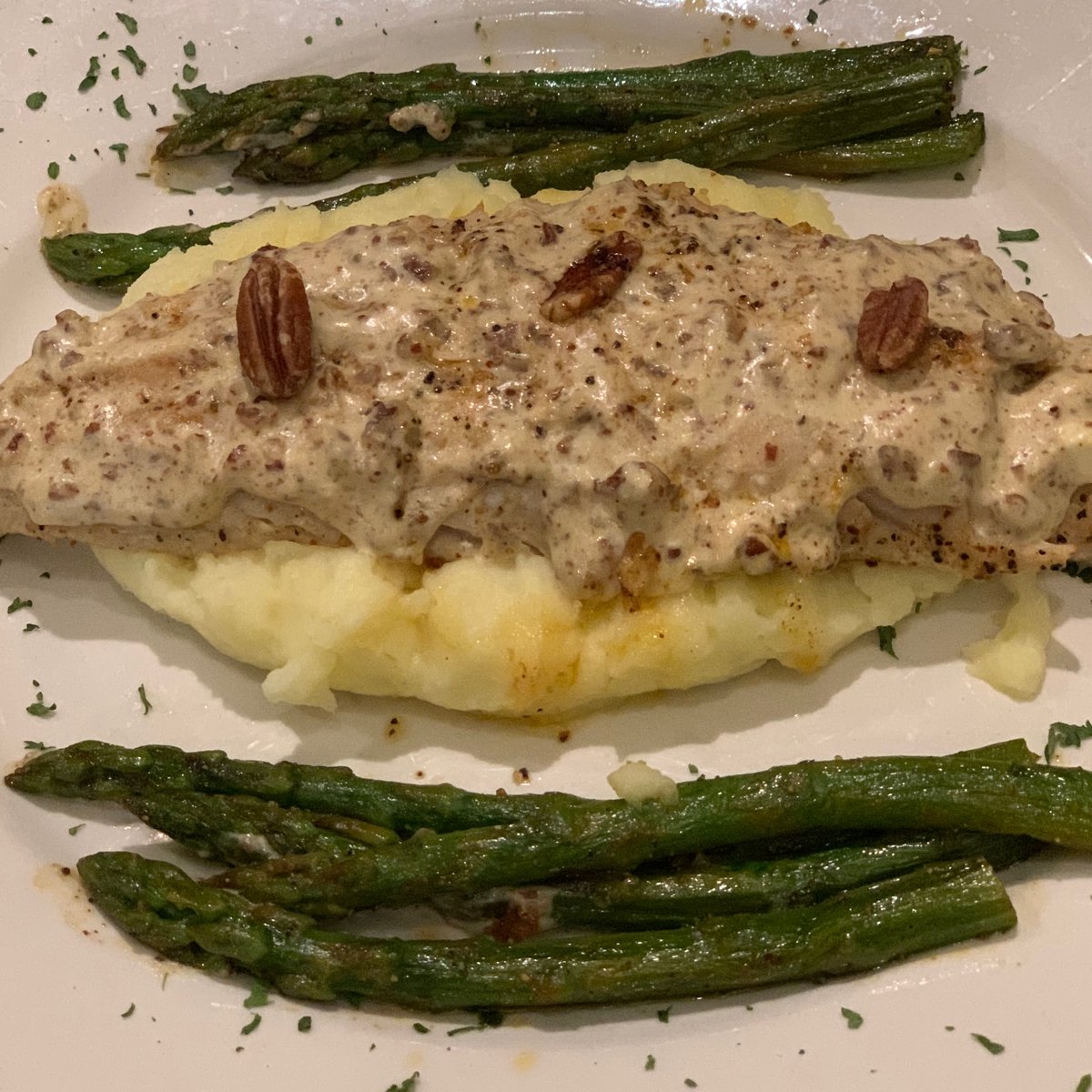 Our newest walleye special - $22
A grilled fillet served on a bed of mashed potatoes and topped with a creamy pecan sauce. Grilled asparagus on the side.