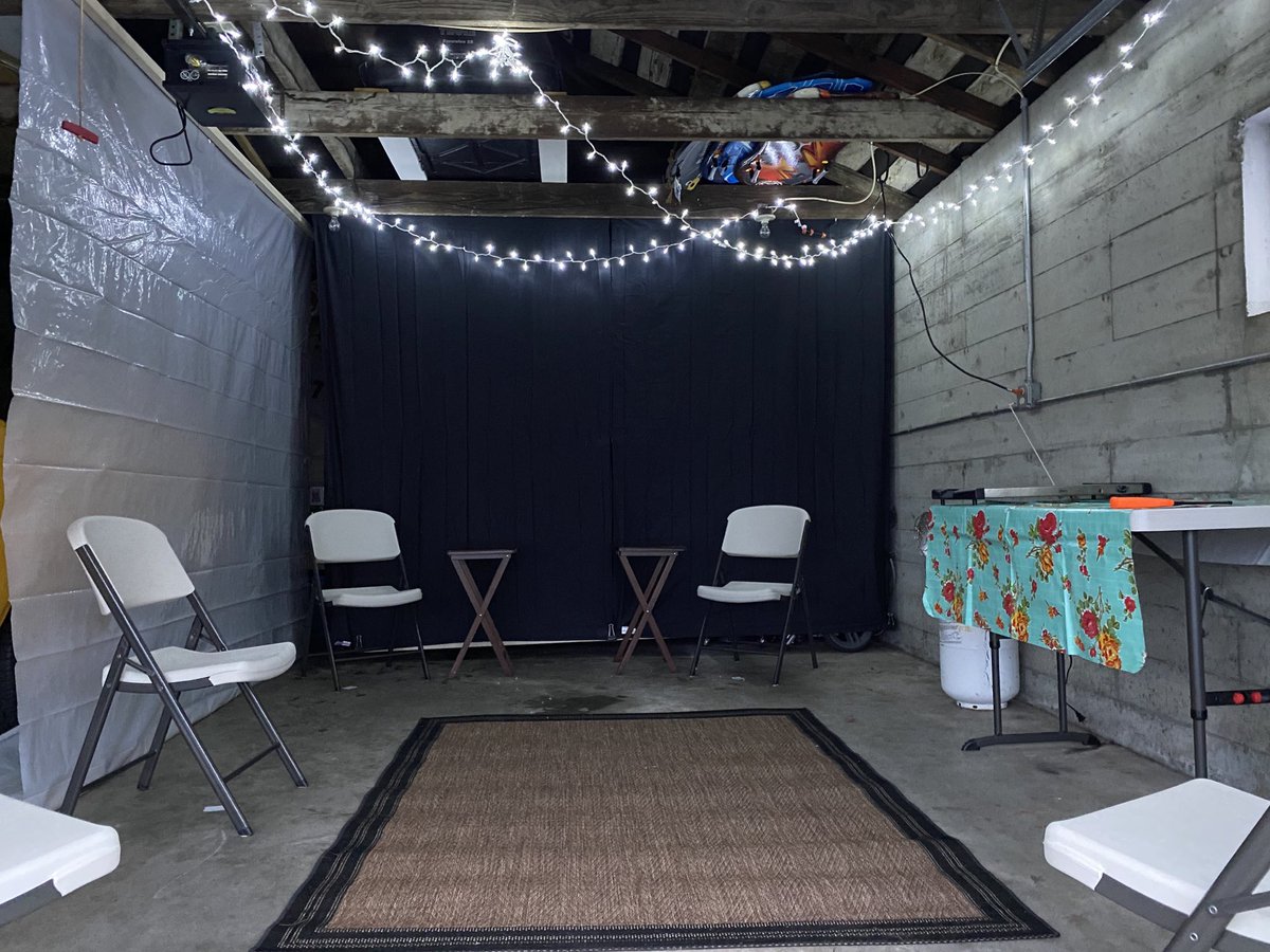 DavePridemore's tweet photo. A COVID-19 living room (garage) ... separated by 6 feet ... open air ... w/two heaters and a few barriers to block in warmth and hide “that garage look”.  Come on over HGTV. https://t.co/Mz9lpVzHio