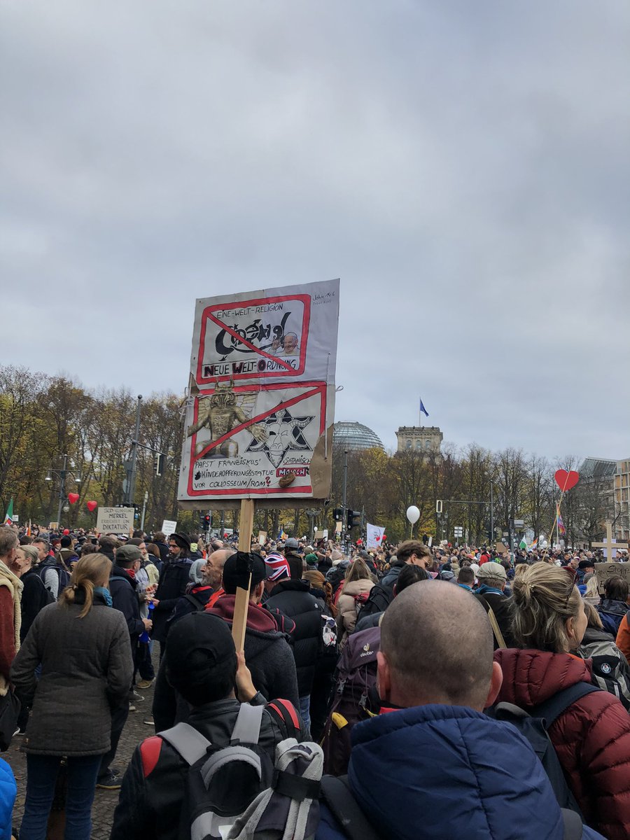 antisemitic bingo on a sign at brandenburger tor: star of david, new world order, satanic conspiracy, ritual murder of children.  #b1811