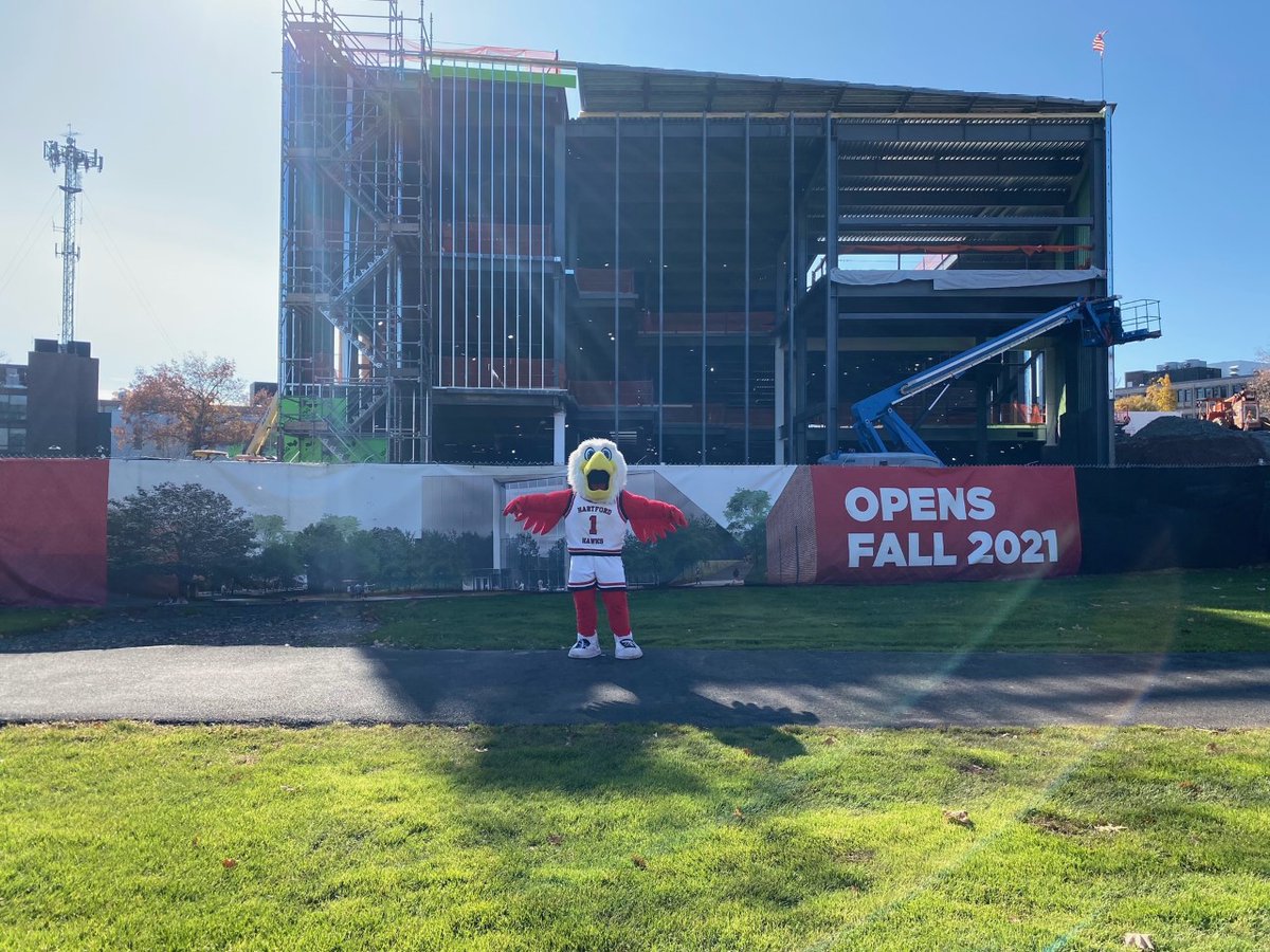 UofHartford's tweet photo. Howie the Hawk is showing off the progress of the new academic building! Have you seen the latest renderings? Check them out at https://t.co/DwNfnXHwPv! #UHart https://t.co/qEAf0GxBsC