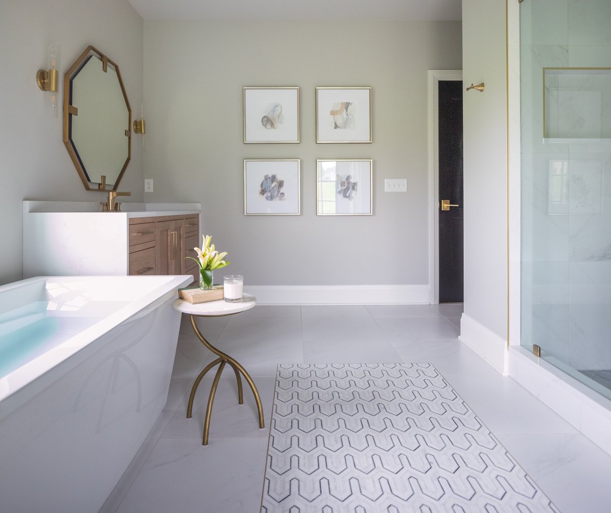 A bathroom you never want to leave. 💧
⠀⠀
Design: @coomerandco 
Photography: <a href="/kristen/">Kristen Hilderman</a>.mayfield 
Contractor: @dougmconstruction 
#justtileit #deltafaucet #coomerandco #masterbath #gold #creaativewood #ipreview via @preview.app