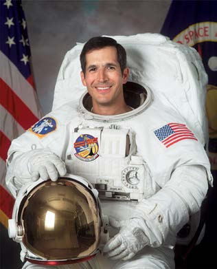 NIHB1's tweet photo. John Herrington, a member of the Chickasaw Nation, became the first Native American to fly in space on November 23, 2002. On his trip, Herrington took his Nation’s flag as well as a traditional flute.  #AIANHeritageMonth #NASA https://t.co/c4IUg7SmzM
