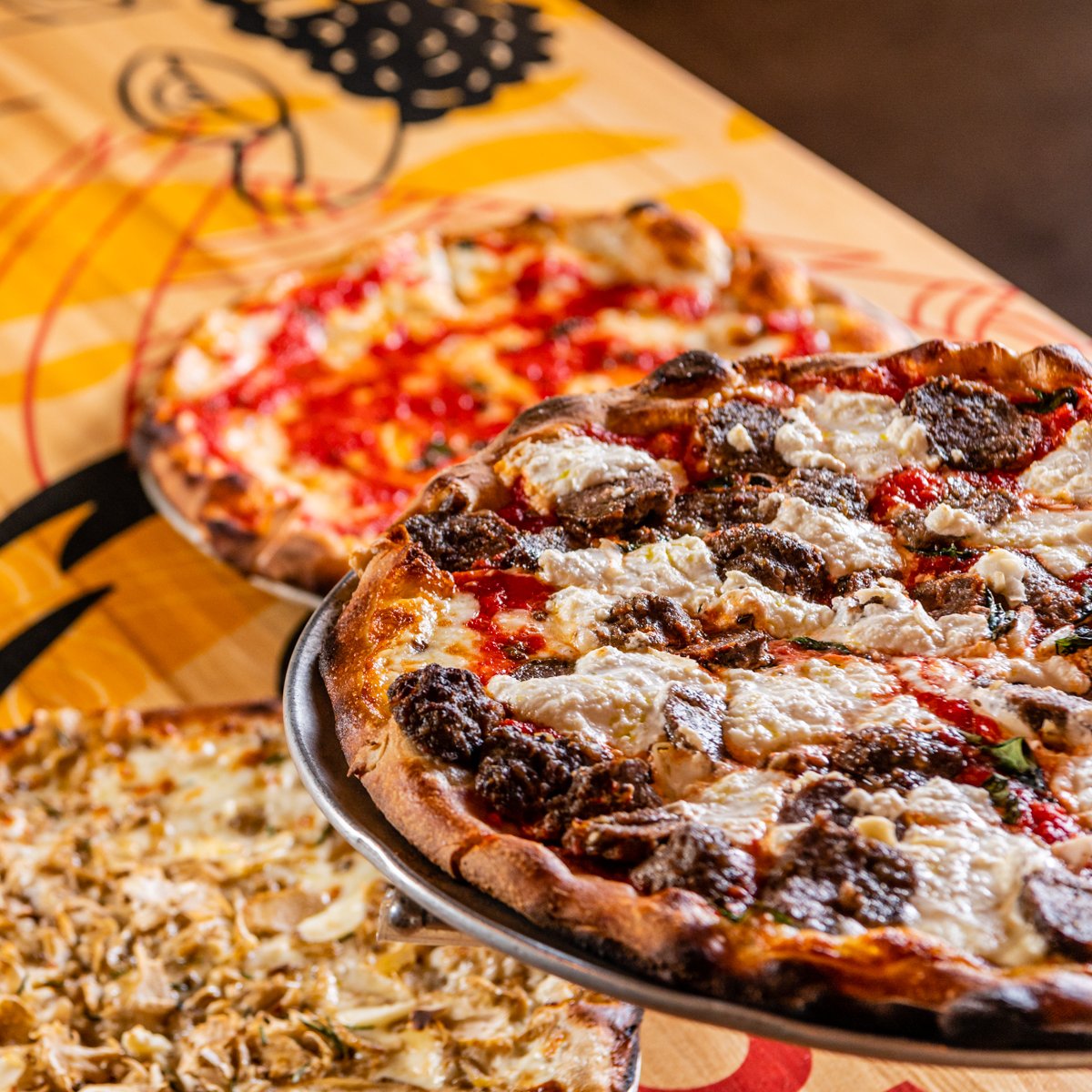 A crispy, thin crust, chewy interior, and carefully curated toppings -- now that's the great American pizza experience.