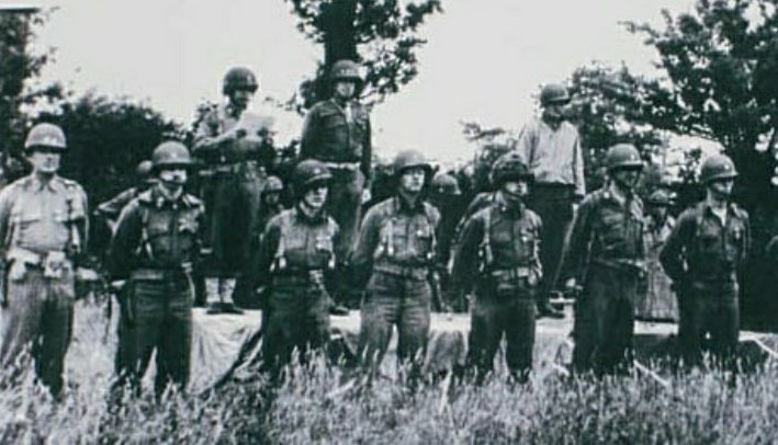 Lieutenant General Omar Bradley presenting Distinguished Service Cross (DSC) medals in Carentan, Normandy, France, on July 2, 1944, to officers of the 101st Airborne Division.1/