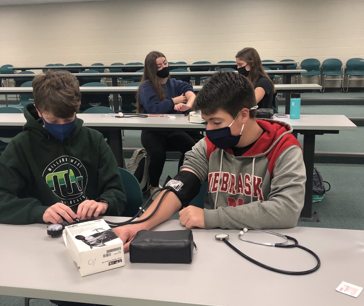 MWHOSA's tweet photo. Masked up, sanitized and continuing to learn! Millard West HOSA practicing blood pressure skills. #futurehealthprofessionals @jsutfin @getiemann @MWHSactivities @hosafhp https://t.co/6QGSTJFaqv