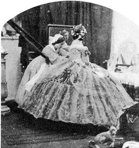 dressing with the assistance of several maids who require long poles to lift her dress over her head and other ingenious means of navigating her enormous hoopskirt.