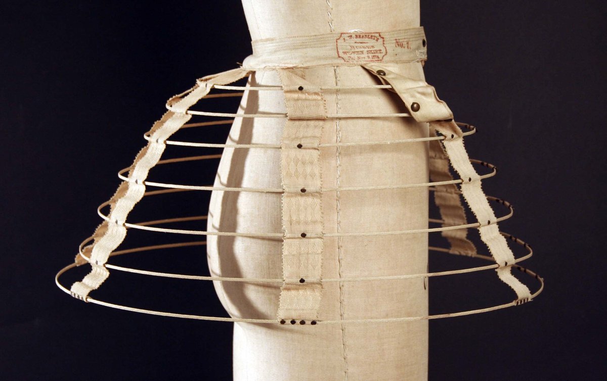 As the fashion for crinolines wore on, their shape changed. Instead of the large bell-like silhouette previously in vogue, they began to flatten out at the front and sides, creating more fullness at the back of the skirts (sometimes called eliptical crinolines).