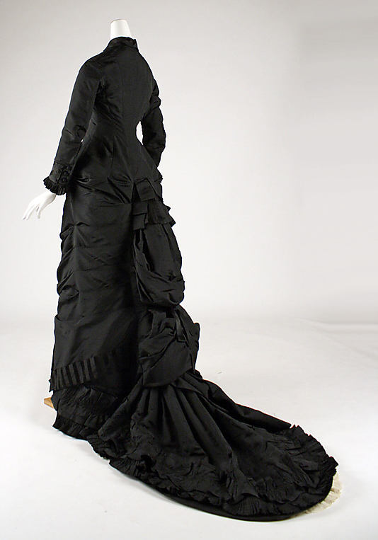 By the 1880s, the soft curve bustle dresses of the early 1870s were replaced with a new distinct silhouette featuring a severely tailored figure from the front and added draperies to the back.