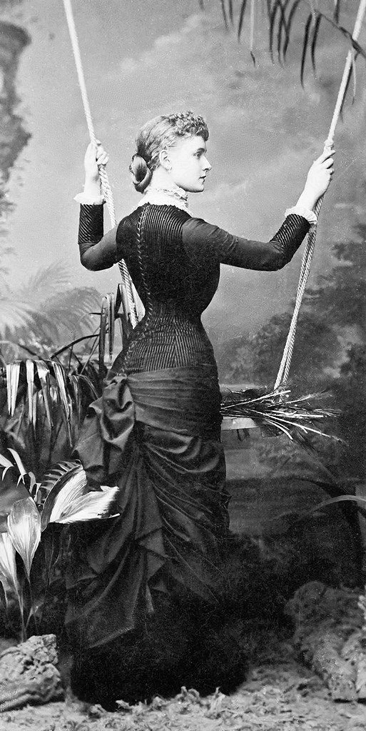 Basques, pointed waists, coat bodices, and round waists with belts were all worn with the new bustle skirts; the selection of the particular style of top was made to suit the figure of the wearer.