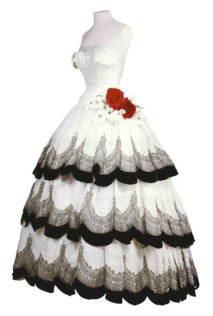 These voluminous skirts with their yards of excess fabric presented a sharp counterpoint to the practical skirts and clothing rations of the war years.