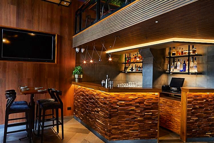 Wall Cladding at Petisco Goa.A #gastrobar with creatively curious food, cheeky cocktails & a vibrant ambience.
 #architecturedesign #barinteriors #officeinteriors #woodencladding  #livingroomstyle   #wallcladding #wallcovering #goaarchitecture