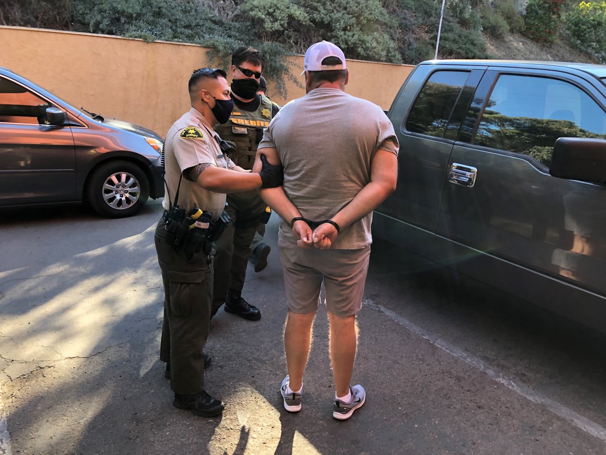 Deputy arresting a man during a prostitution human trafficking sting.