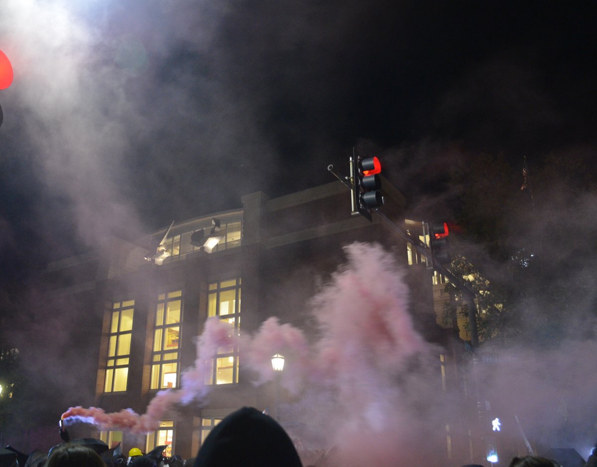 One "smoke bomb" was dropped in a trash can as students marched. A couple students held one or two more above their heads as they marched.