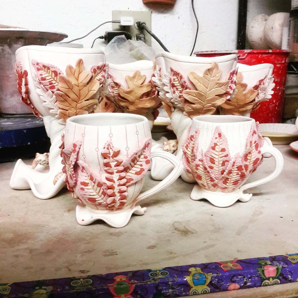 StasevichStudio's tweet photo. Desperately hoping I didn't overdo the glaze layers on the cherry leaves. But that is TWO teacups that are ready for their trip through the kiln, now. It feels remarkably good to be getting these very long projects done #teacup #cherryleaf #autumnleaves #natureart #porcelain https://t.co/npNuh1w53F