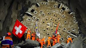 HISTORY OF GOTTHARDAccording to the Swiss rail service, it took 43,800 hours of non-stop work by 125 laborers rotating in three shifts to lay the tunnel’s slab track. The same type of circular drill was used to create the tunnel as was employed in the CERN project.
